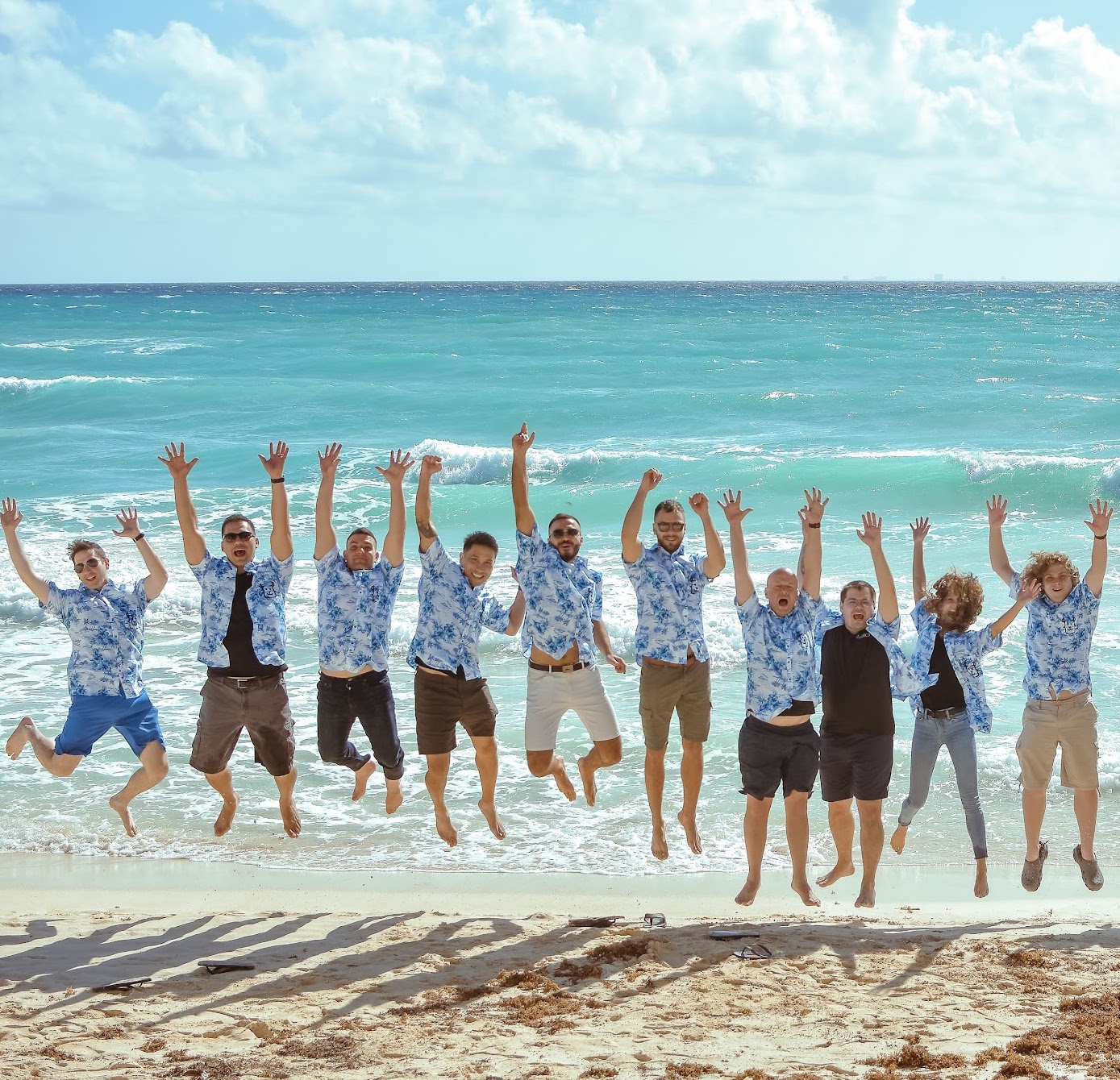 happy developers frolicking on the beach